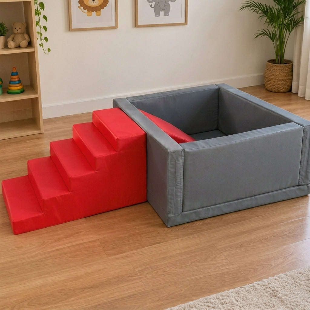 A gray rectangular pet playpen with an attached red four-step ramp, placed on a light wood floor in a child's room with framed animal art, a shelf, and a potted plant.