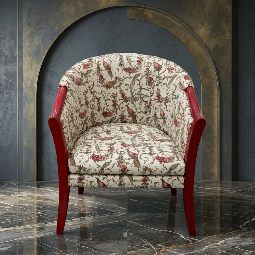 A classic armchair with a red wooden frame and cream-colored fabric upholstered in a detailed floral and bird pattern, set against a dark textured wall with an arched recess.
